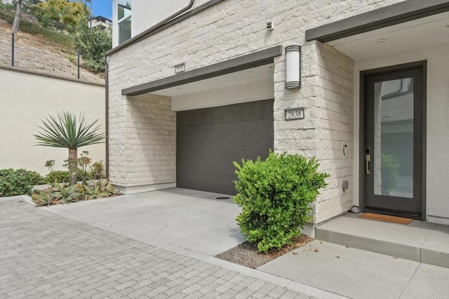 view of exterior entry featuring a garage