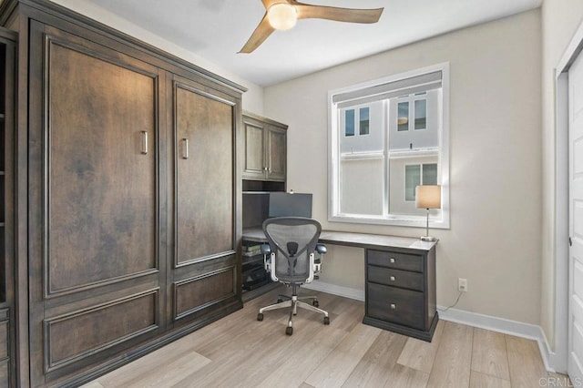 home office featuring light wood-type flooring, baseboards, and a ceiling fan