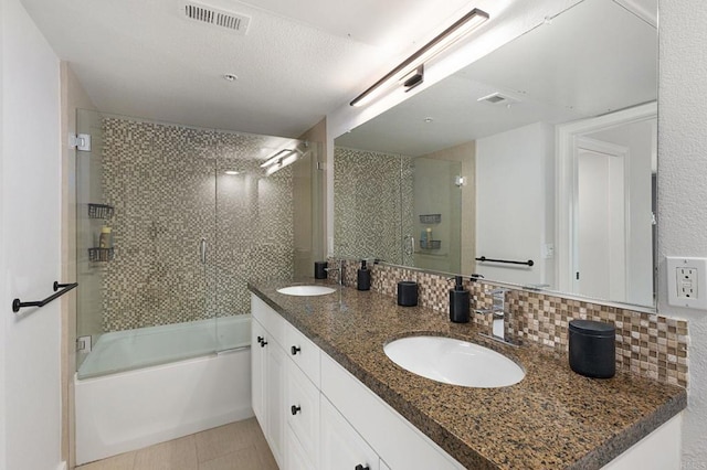 full bathroom featuring backsplash, double vanity, visible vents, and a sink