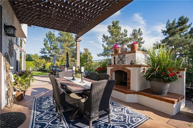 view of patio featuring an outdoor fireplace, outdoor dining area, and a pergola