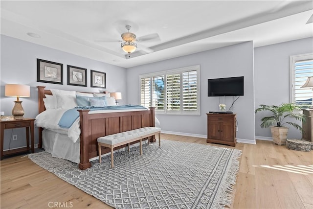 bedroom with baseboards, a ceiling fan, and wood finished floors