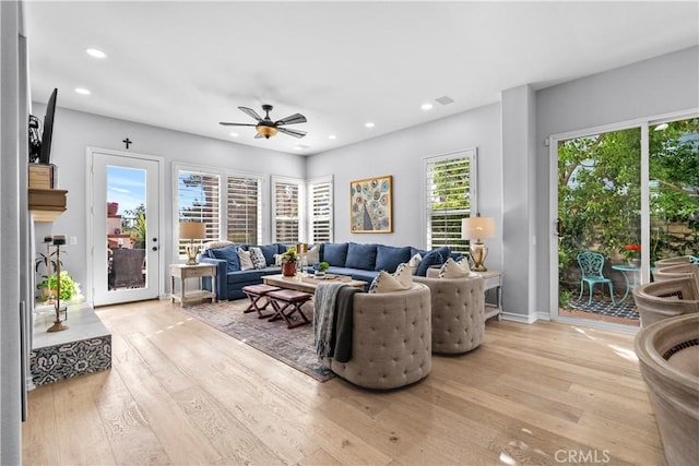 living room featuring recessed lighting, baseboards, a ceiling fan, and light wood finished floors