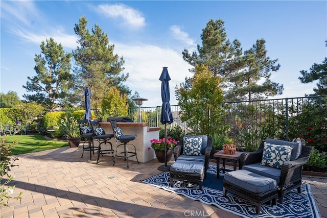 view of patio / terrace with fence and outdoor dry bar