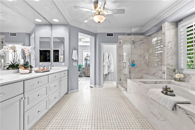 bathroom with a sink, a ceiling fan, a stall shower, and visible vents