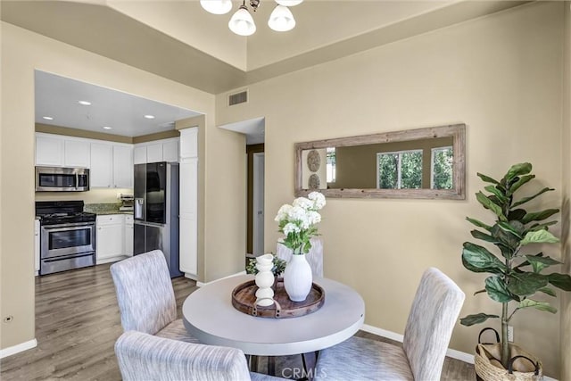 2641 Dunstan Dr, Tustin, CA 92782 - dining space with wood finished floors, baseboards, a chandelier, and visible vents