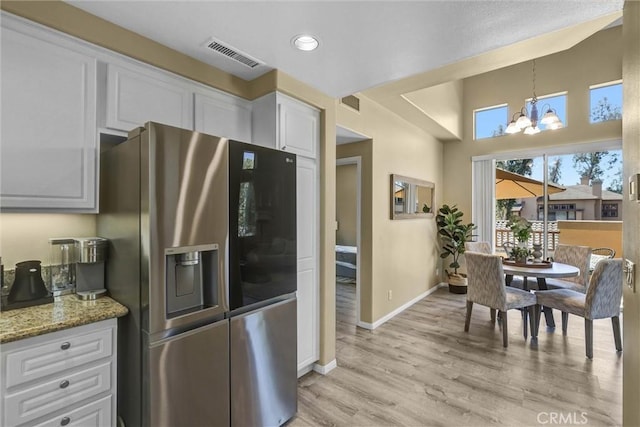 2641 Dunstan Dr, Tustin, CA 92782 - kitchen with visible vents, baseboards, stainless steel refrigerator with ice dispenser, white cabinets, and a notable chandelier