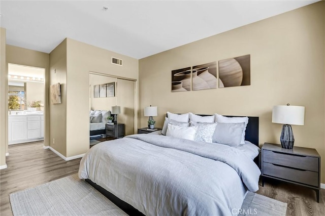 2641 Dunstan Dr, Tustin, CA 92782 - bedroom featuring visible vents, wood finished floors, baseboards, a closet, and ensuite bathroom