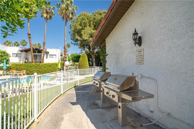 2240 S Palm Canyon Dr Unit 20, Palm Springs, CA 92264 - view of patio / terrace with fence, area for grilling, and a community pool