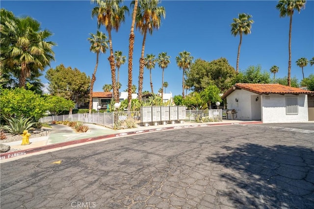 2240 S Palm Canyon Dr Unit 20, Palm Springs, CA 92264 - view of front of home with stucco siding, fence, and a tiled roof