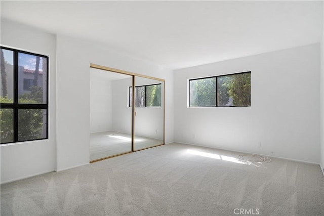 2240 S Palm Canyon Dr Unit 20, Palm Springs, CA 92264 - unfurnished bedroom with multiple windows, carpet floors, and a closet