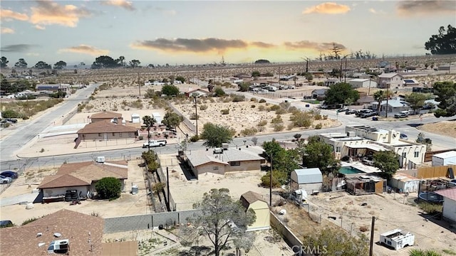 aerial view at dusk featuring a residential view