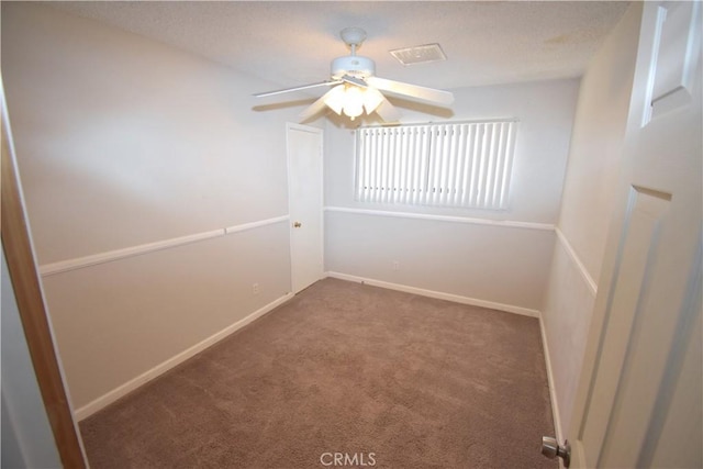 carpeted spare room with a ceiling fan, baseboards, and visible vents