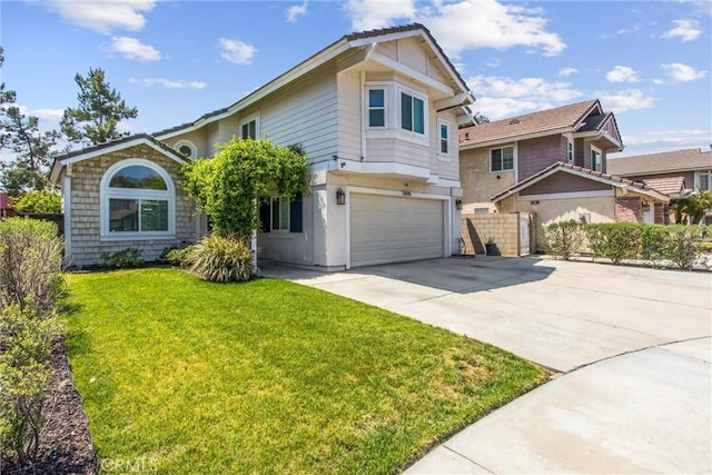traditional-style home featuring a garage, a front lawn, fence, and concrete driveway