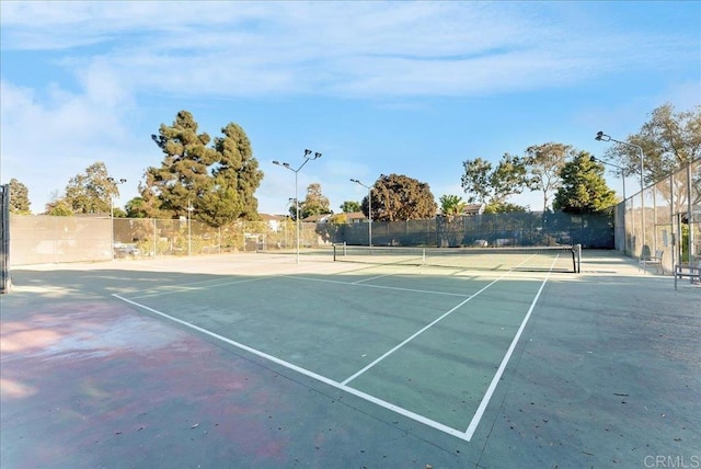 view of sport court with fence