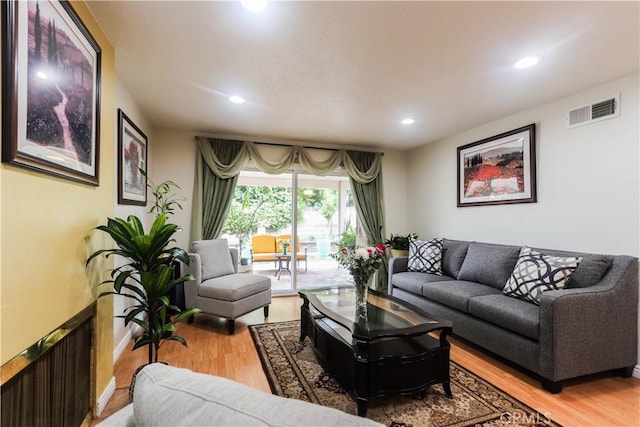 living area with recessed lighting, visible vents, and light wood-style flooring