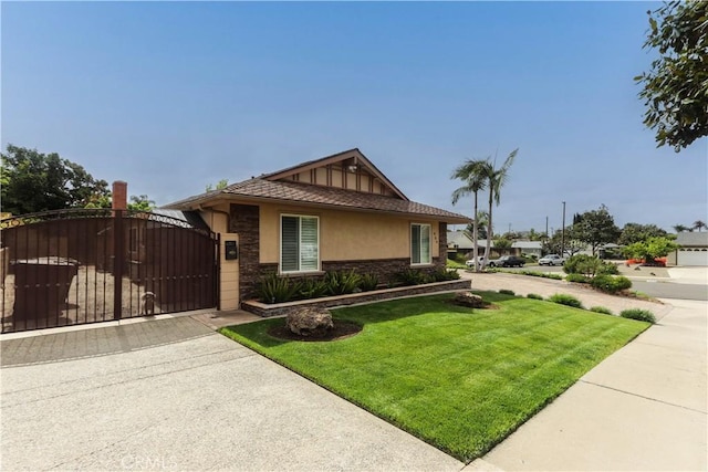 view of front of house featuring a gate, stucco siding, a front yard, and stone siding