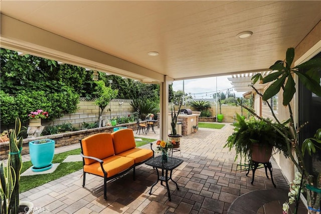 view of patio / terrace featuring a fenced backyard, an outdoor hangout area, and outdoor dining space
