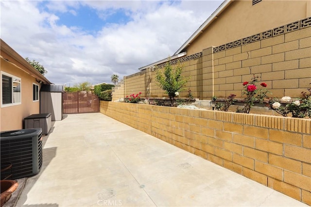 view of patio / terrace featuring cooling unit and a fenced backyard