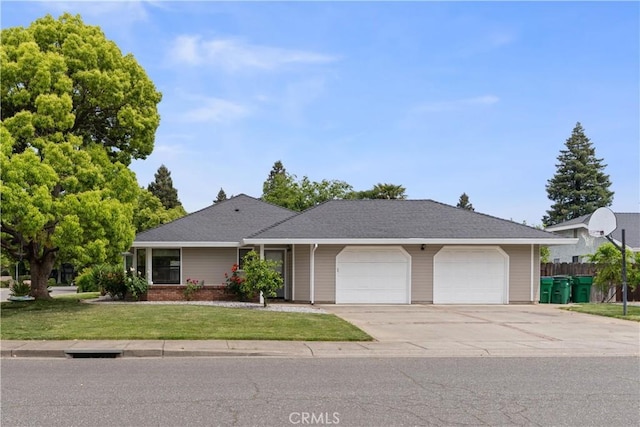 single story home featuring a garage, a front lawn, and driveway