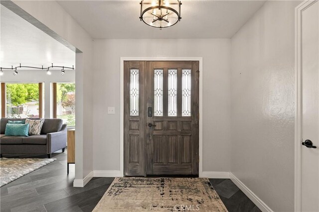 1635 Almendia Dr, Chico, CA 95926 - foyer featuring baseboards, a chandelier, and dark wood-style flooring