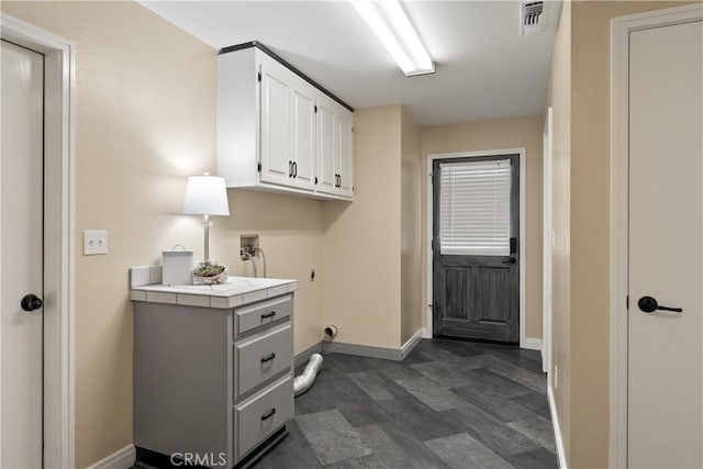 clothes washing area with washer hookup, hookup for an electric dryer, visible vents, cabinet space, and baseboards