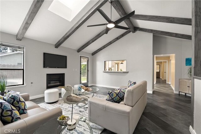 1635 Almendia Dr, Chico, CA 95926 - living room featuring beam ceiling, a skylight, a ceiling fan, a glass covered fireplace, and baseboards