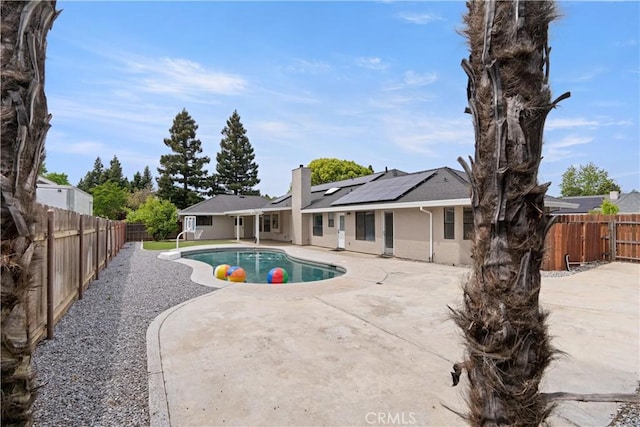 view of swimming pool with a fenced in pool, a fenced backyard, and a patio area