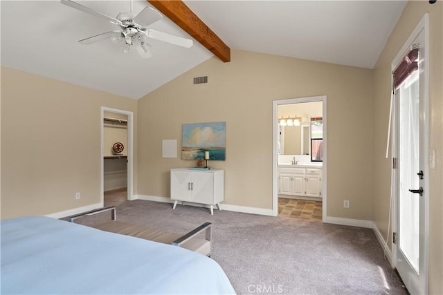 bedroom with light colored carpet, a walk in closet, a sink, vaulted ceiling with beams, and visible vents