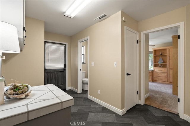 interior space featuring visible vents and baseboards