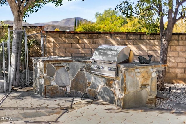 5580 Bromely Dr, Oak Park, CA 91377 - view of patio featuring fence, area for grilling, exterior kitchen, and a mountain view
