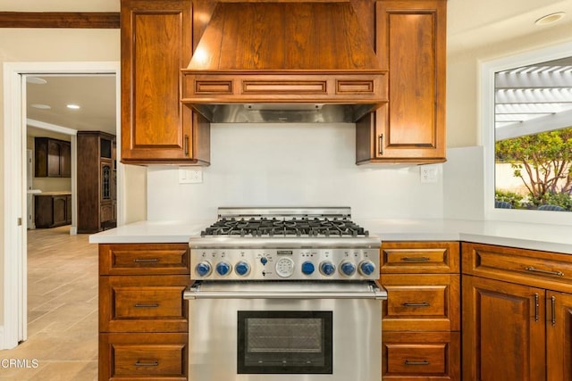 5580 Bromely Dr, Oak Park, CA 91377 - kitchen featuring brown cabinetry, recessed lighting, high end stainless steel range oven, light countertops, and custom range hood