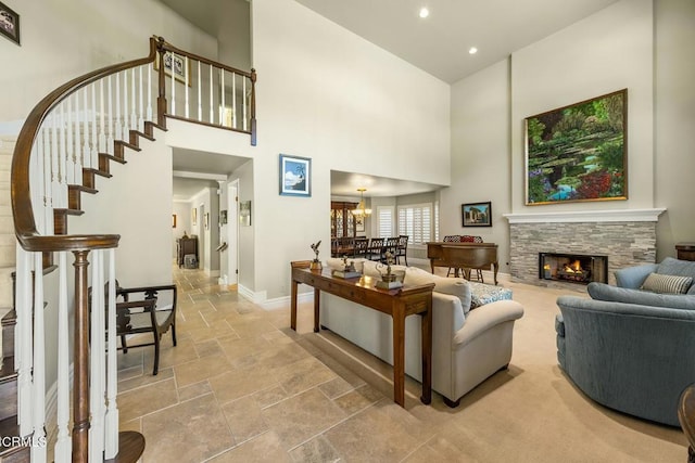 5580 Bromely Dr, Oak Park, CA 91377 - living room with recessed lighting, stone tile flooring, baseboards, a stone fireplace, and a high ceiling