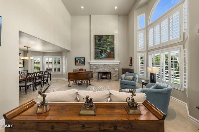 5580 Bromely Dr, Oak Park, CA 91377 - living room with a chandelier, baseboards, a towering ceiling, and a stone fireplace