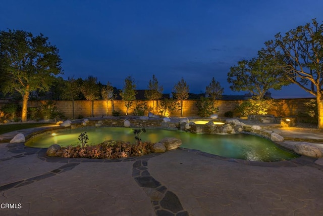 5580 Bromely Dr, Oak Park, CA 91377 - pool at night with a fenced backyard, an in ground hot tub, a patio area, and a fenced in pool
