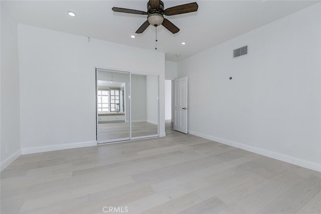 unfurnished bedroom featuring recessed lighting, visible vents, a closet, and light wood-style floors