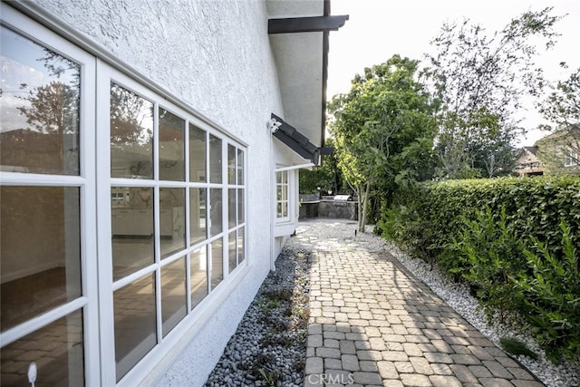 view of side of home with stucco siding