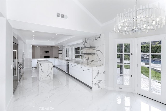 kitchen featuring visible vents, modern cabinets, white cabinets, and vaulted ceiling