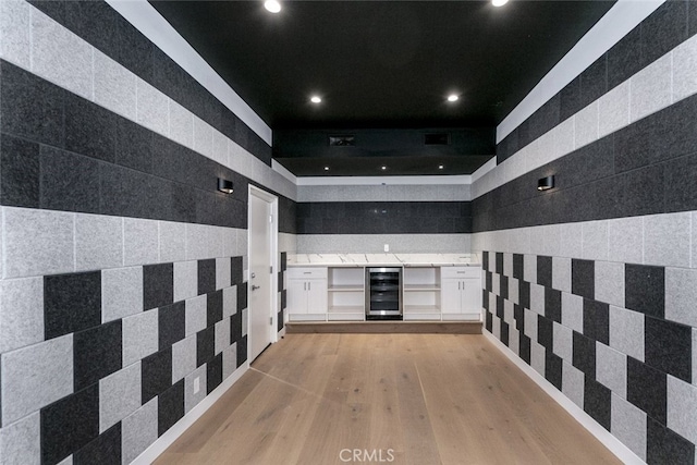 hall featuring recessed lighting, light wood-style flooring, and wine cooler