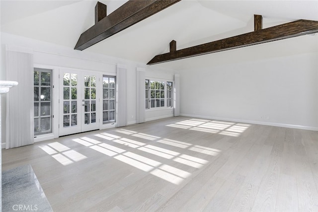unfurnished living room with french doors, beam ceiling, wood finished floors, high vaulted ceiling, and baseboards