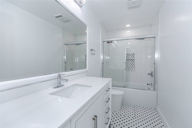 bathroom featuring visible vents, vanity, toilet, shower / bath combination with glass door, and recessed lighting
