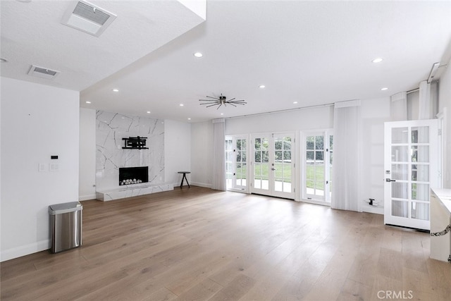 unfurnished living room with visible vents, recessed lighting, and light wood-style floors