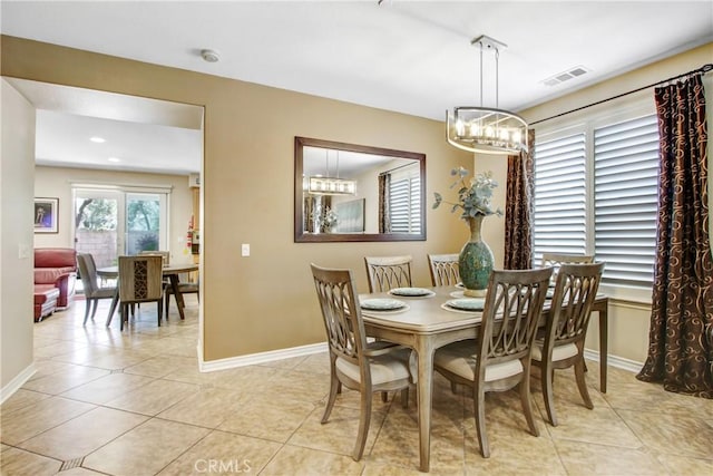 dining area with an inviting chandelier, baseboards, light tile patterned flooring, and visible vents