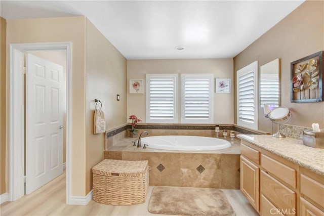 full bathroom featuring vanity and a bath