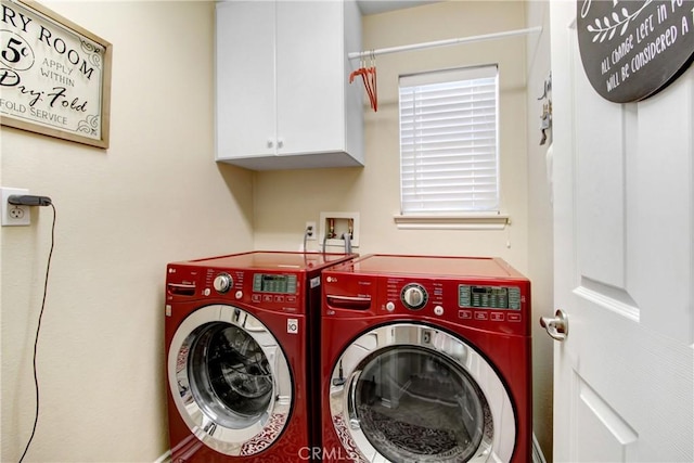 washroom with cabinet space and washing machine and dryer