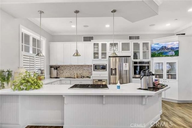 kitchen with visible vents, glass insert cabinets, light wood-type flooring, white cabinets, and stainless steel appliances