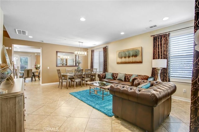 living area featuring visible vents, plenty of natural light, and light tile patterned floors