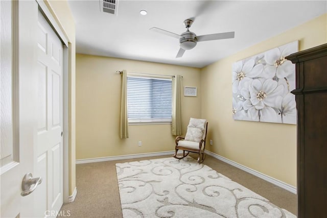 sitting room featuring carpet floors, ceiling fan, baseboards, and visible vents