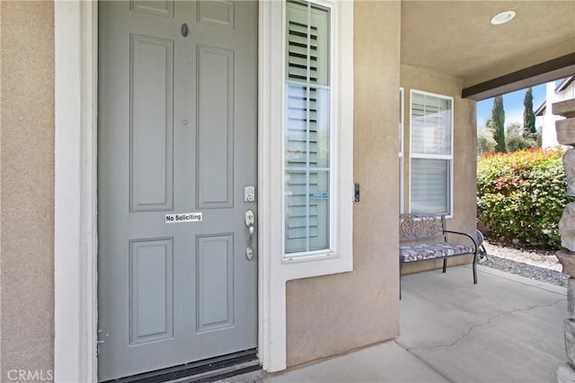 view of exterior entry with stucco siding