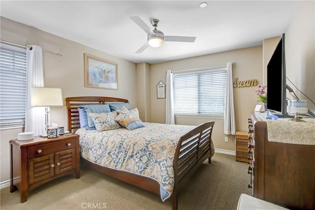 bedroom featuring baseboards, ceiling fan, and carpet flooring