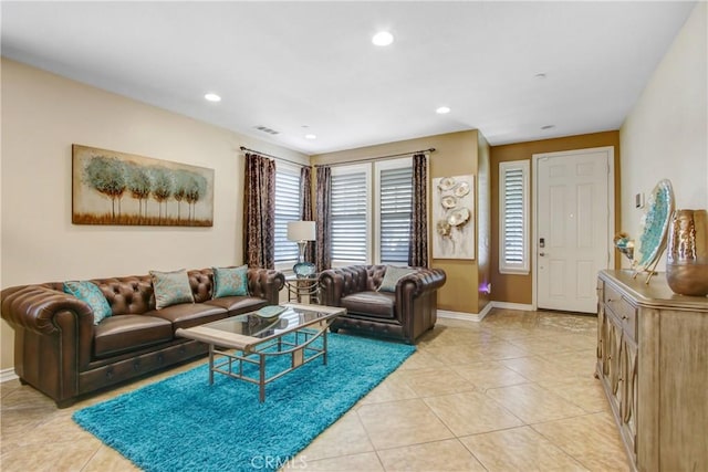 living room with light tile patterned flooring, baseboards, and visible vents